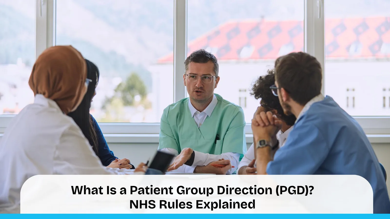 A diverse team of healthcare professionals in scrubs and clinical attire sitting around a table in a bright, modern room, engaged in a collaborative discussion.